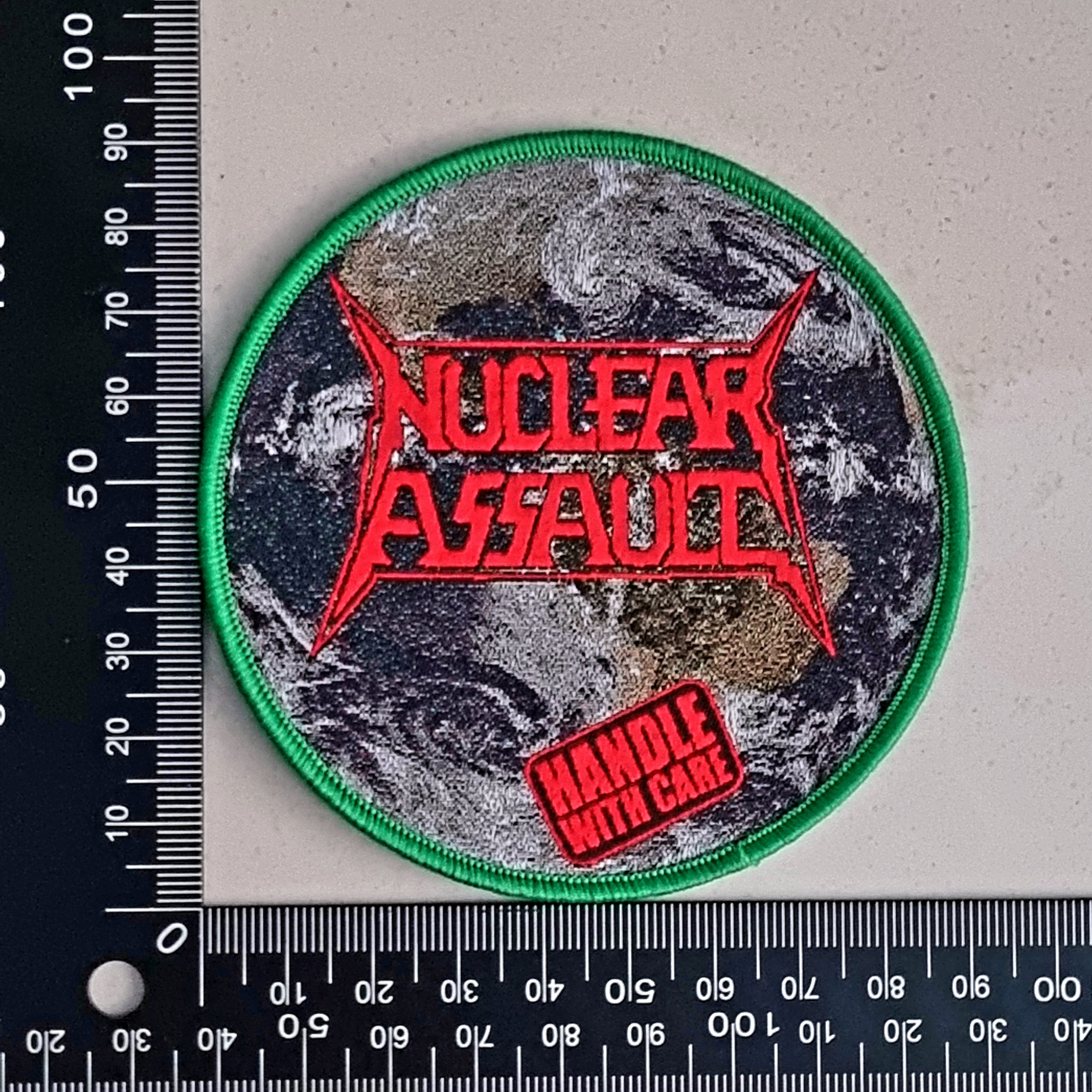 NUCLEAR ASSAULT - Handle with Care - (Green Border) Woven Patch